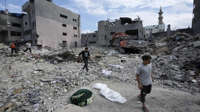 Bodies pile up in the rubble of devastated Gaza