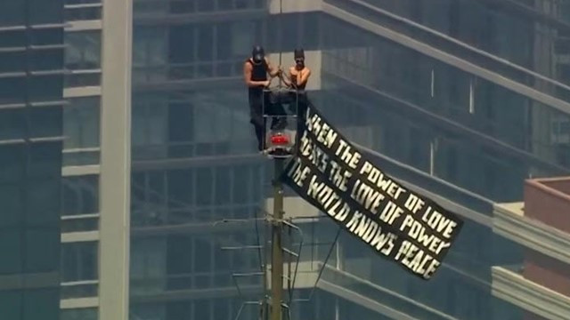 Couple Climbs at Top of Empire State Building in New York